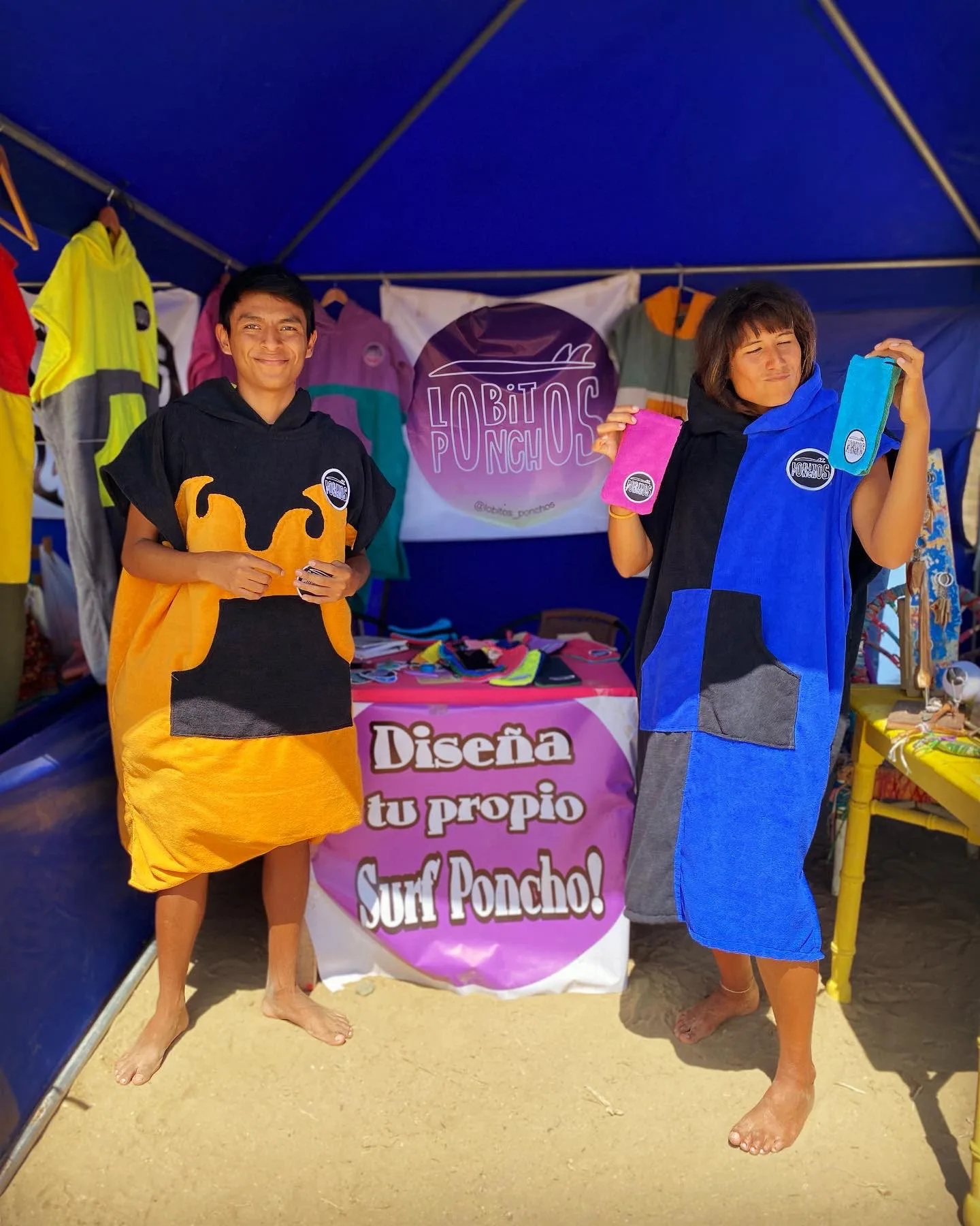 The Lobitos Ponchos stand at a market on the beach